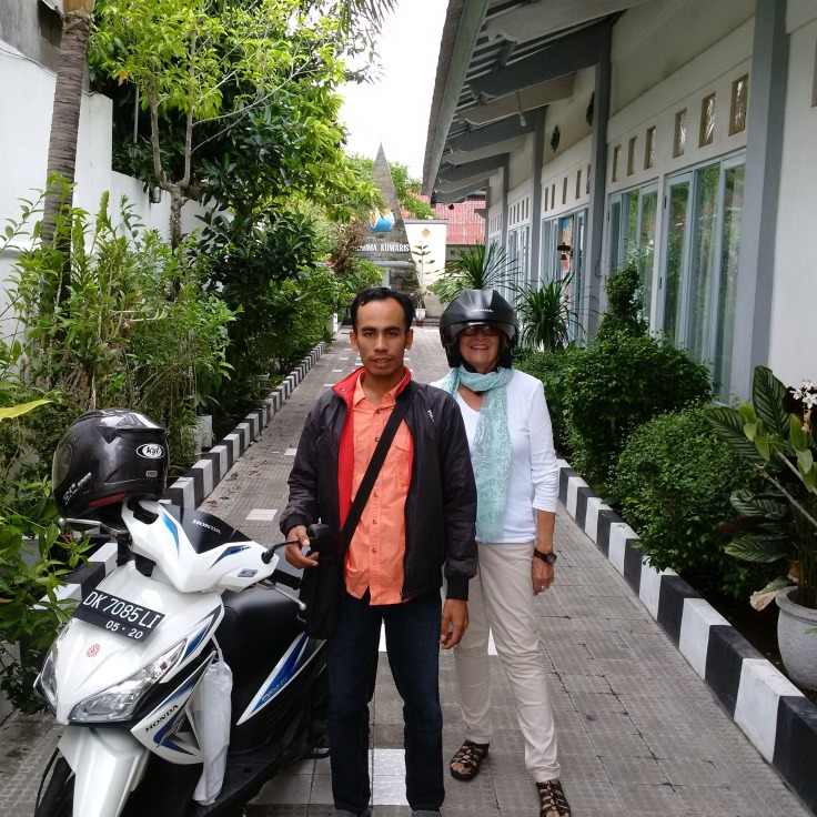 That's me under the head gear! With my taxi motor-scooter driver in Bali!
